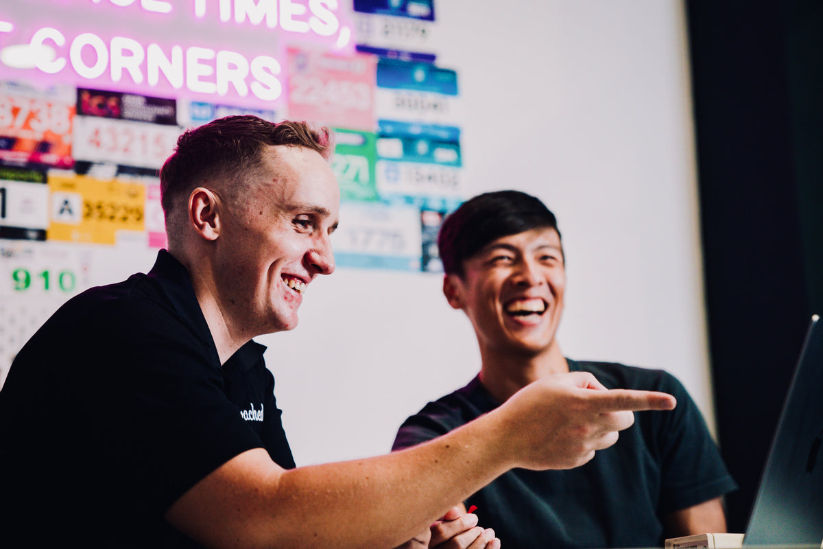 A coach and athlete laugh during a sweat test at the Coached Lab