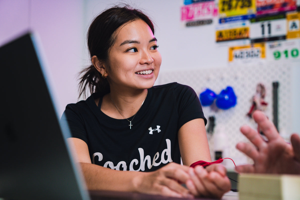A lady smiling during her sweat test at the Coached Lab