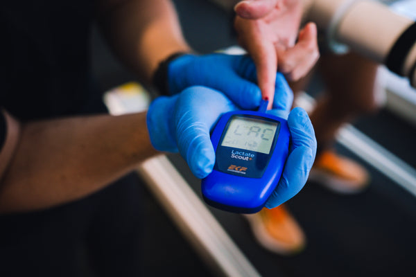 Collecting a blood sample with a lactate scout analyser during a lactate test in the Coached Lab