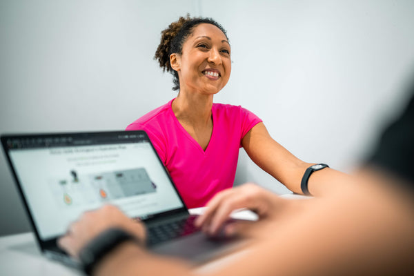 Athlete reviewing sweat test results during a hydration consultation